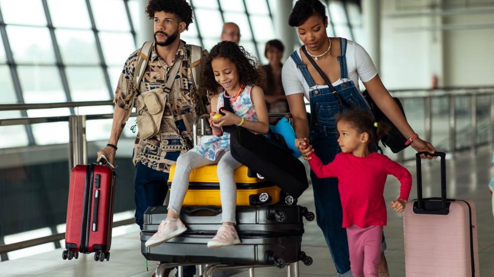 Family walking through the airport